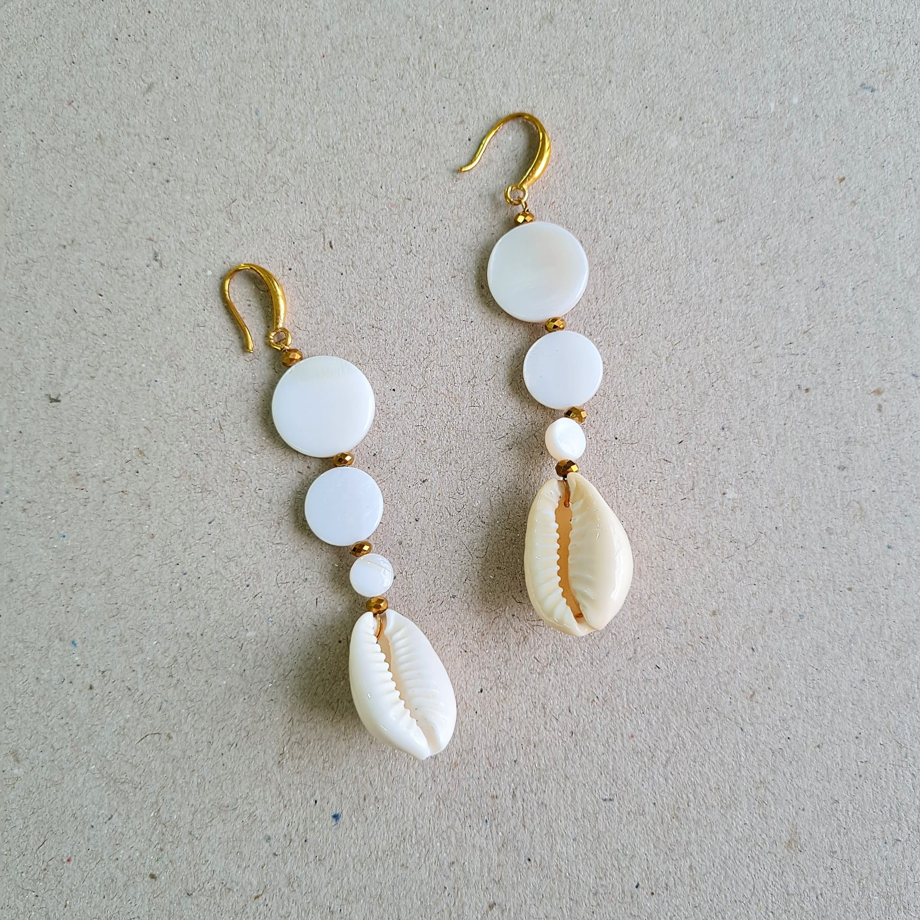 DESCENDING COWRIE SHELL DROP EARRINGS IN GOLD FINISH